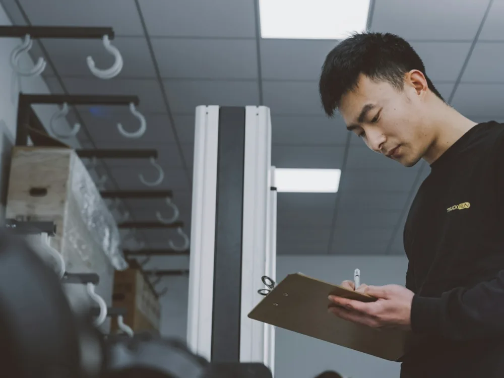 Technician working through a maintenance check sheet on site